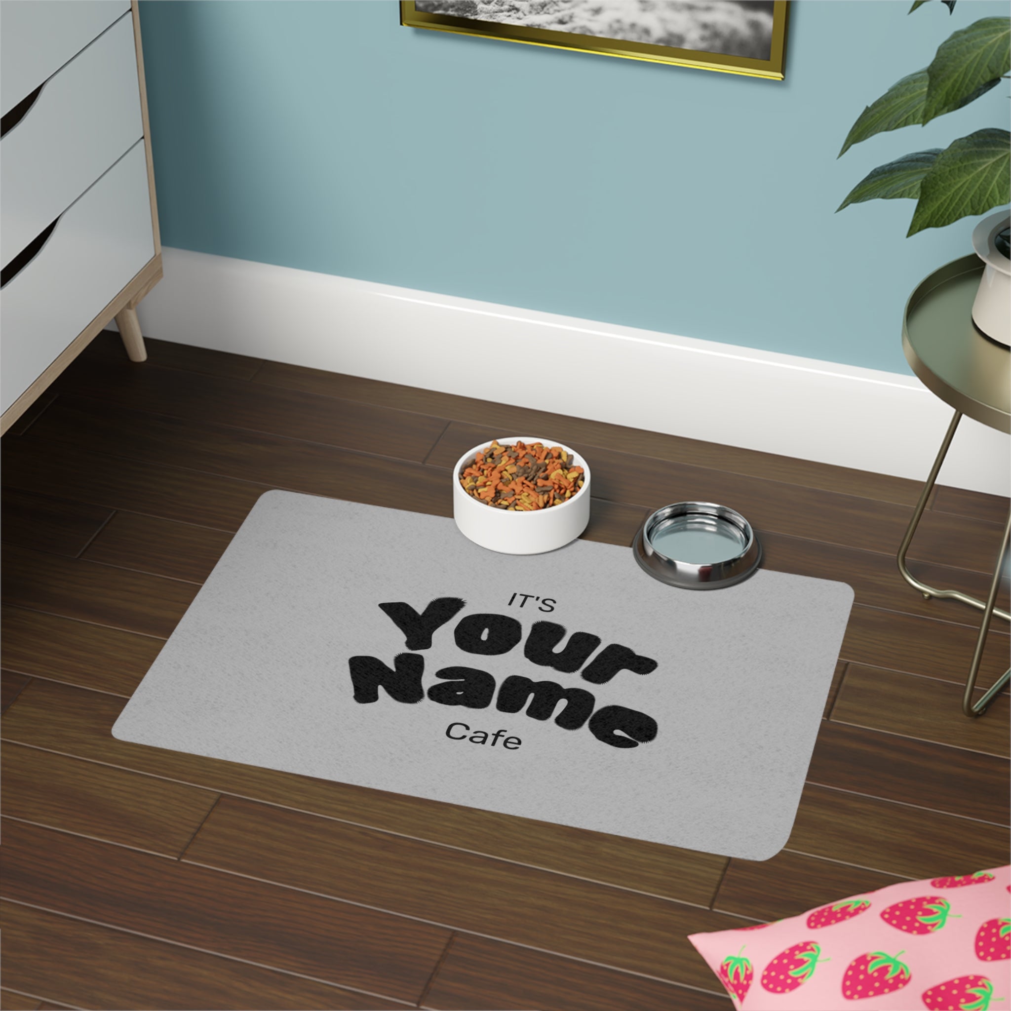 Personalized pet mat with 'It's Your Name Cafe' text on a wooden floor.
